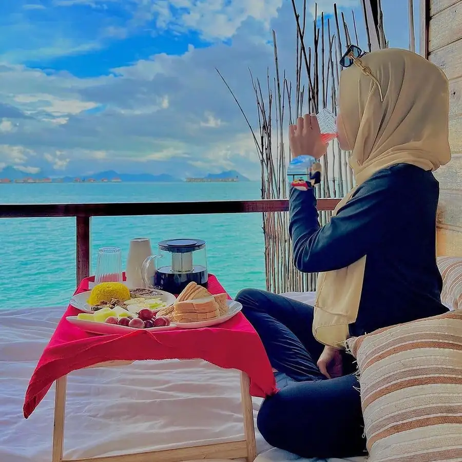 View of the sea from a private overwater room balcony Nusakuya Resort